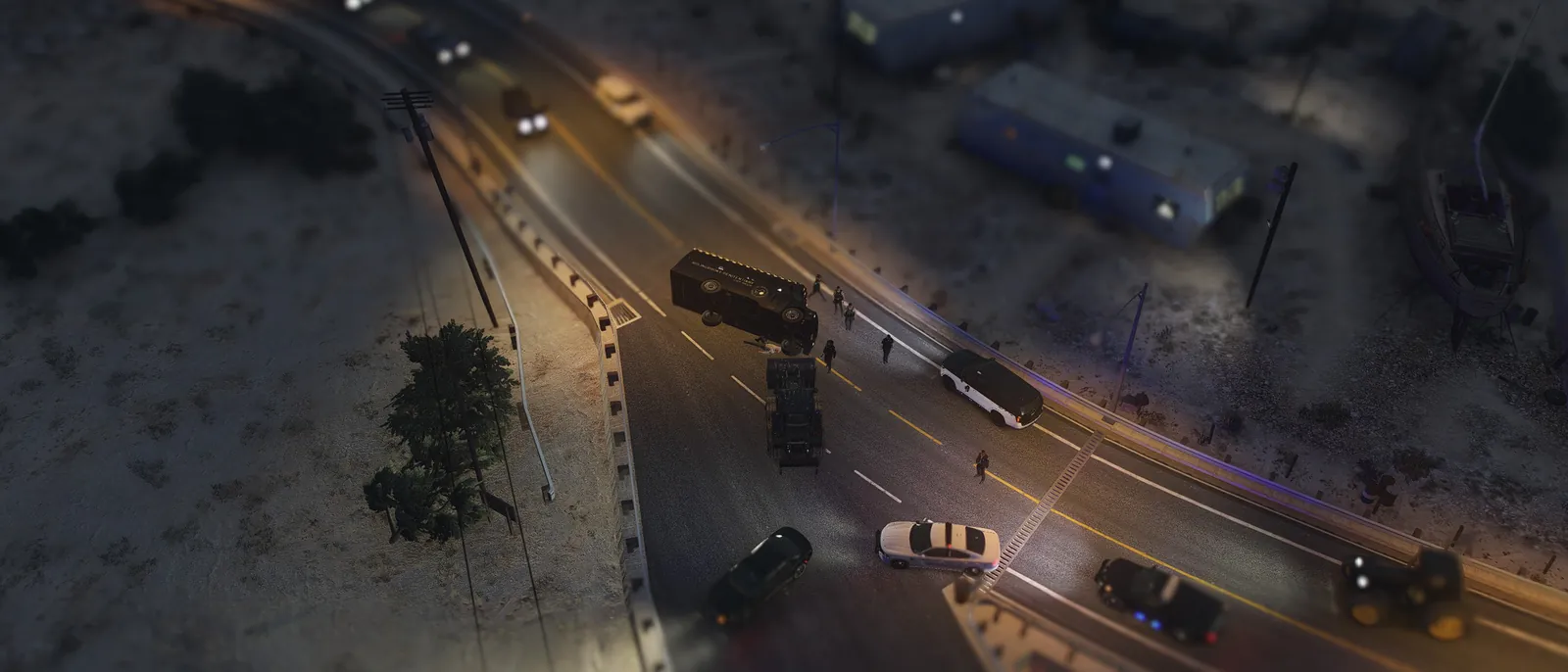 Emergency vehicles on a highway at night, seen from above