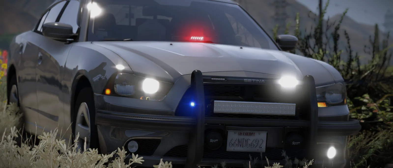An unmarked police car with its lights on at night