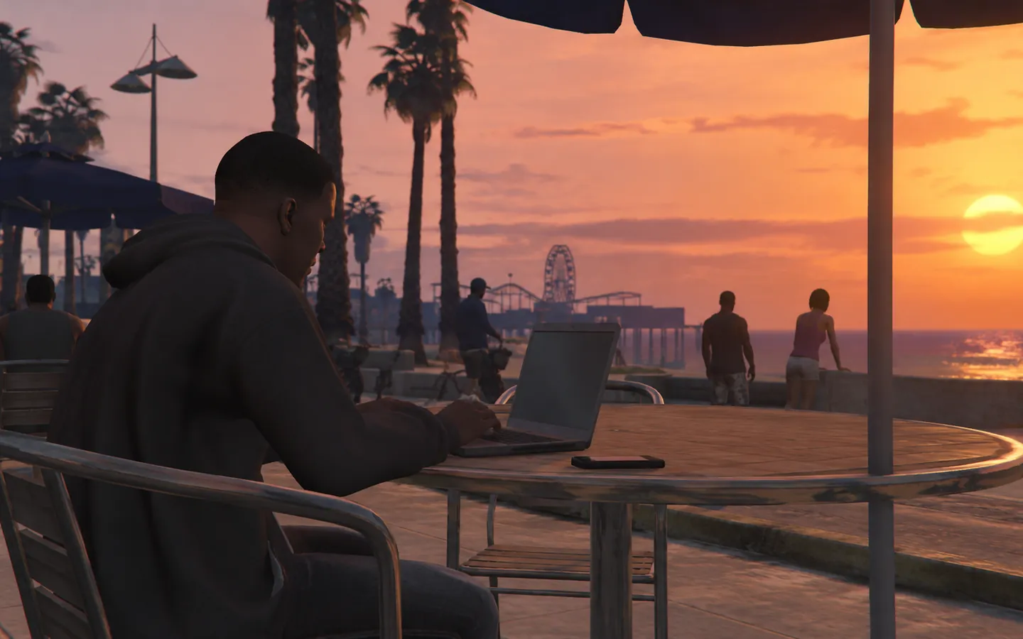 Working on a laptop at a beach cafe at sunset
