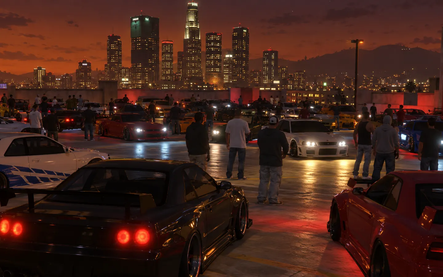 A night-time car meet on a rooftop car park